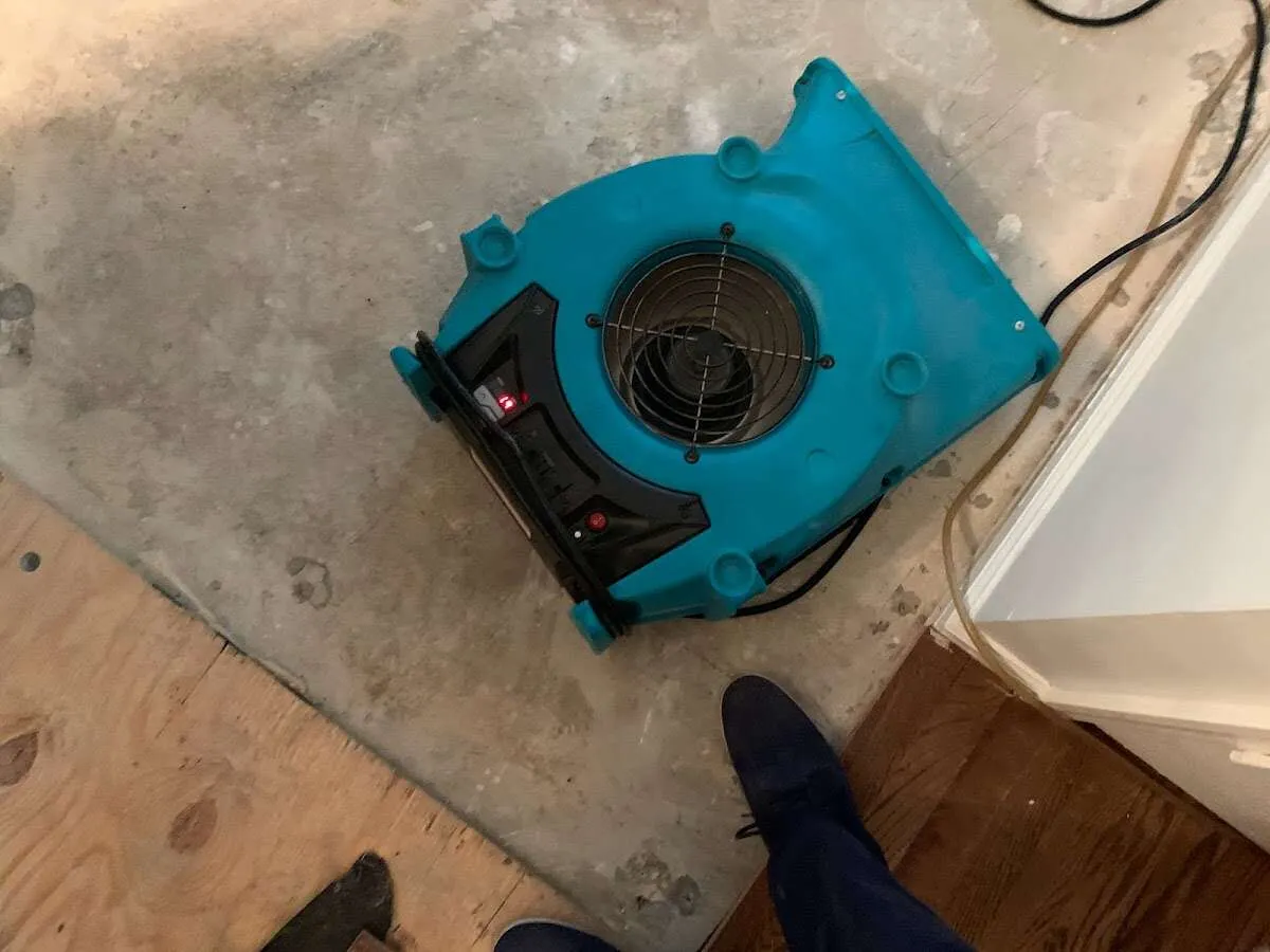 Air mover drying subfloor during Commercial Water Damage Restoration in Poolesville